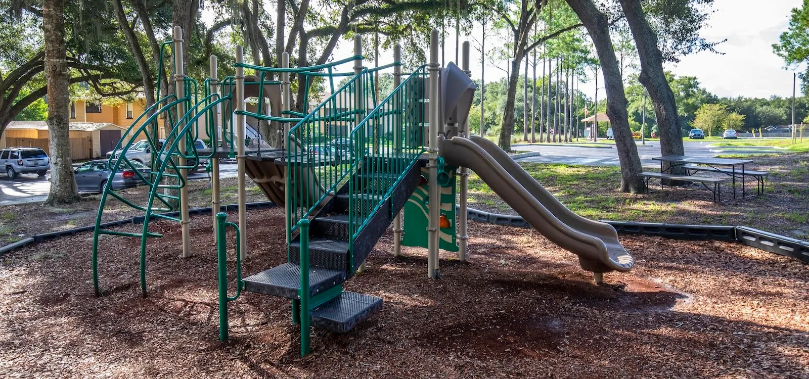 Tree-shaded playground equipment for children